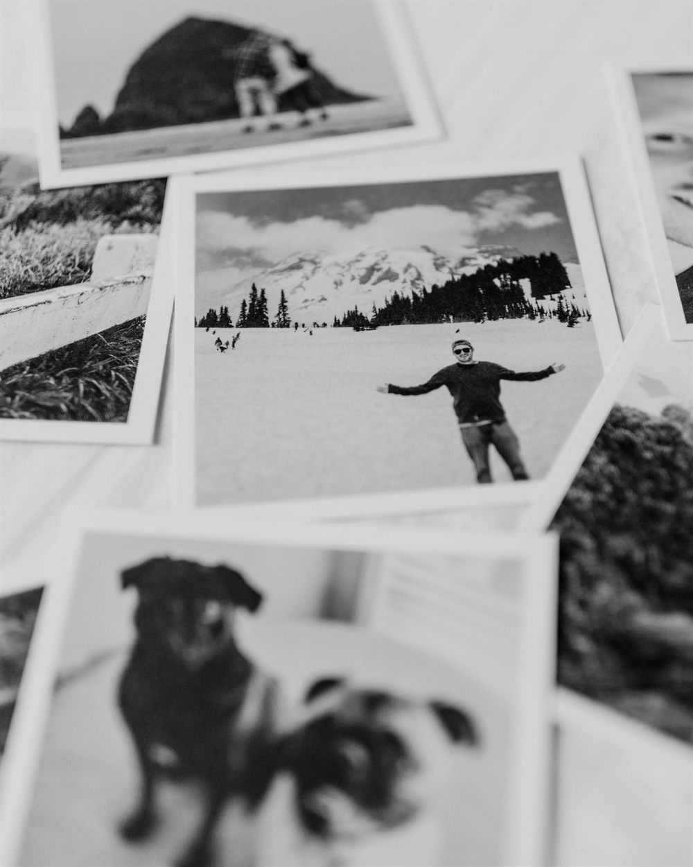 Printed holiday snapshots scattered on a table